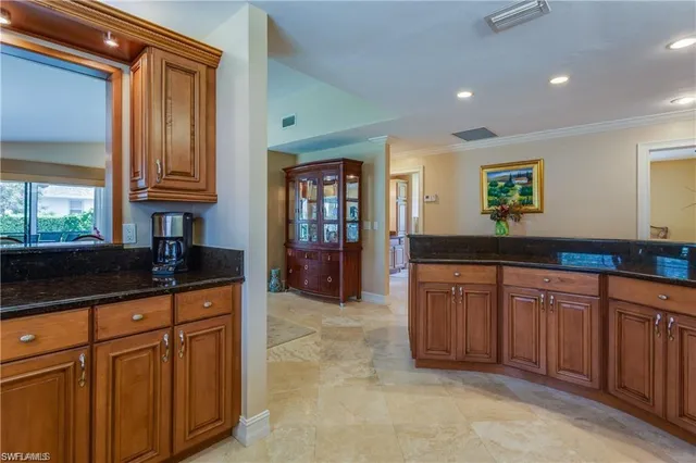 a kitchen with granite countertop a sink and cabinets