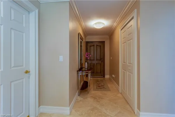 a view of a hallway with wooden shelves