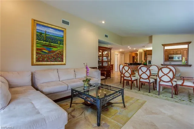 a living room with furniture a table and a painting