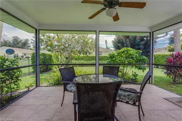 a view of a porch with furniture and garden