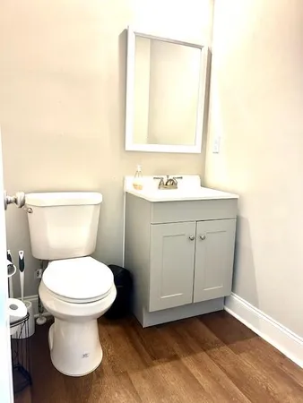 a bathroom with a toilet sink and mirror