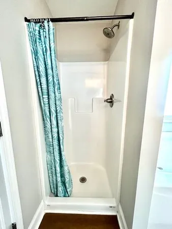 a bathroom with a glass shower door