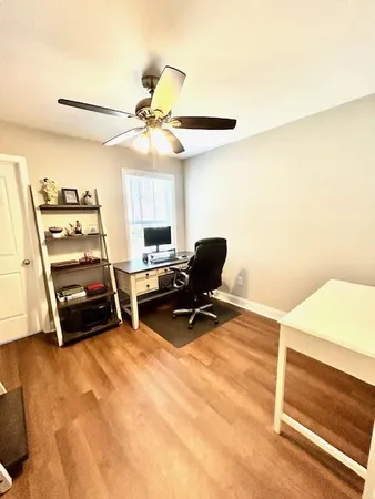 a room with furniture and a ceiling fan
