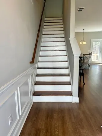 a view of entryway and hall with wooden floor
