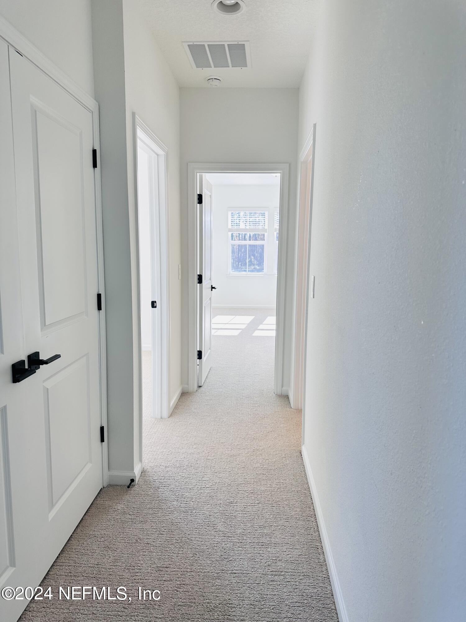 173 Wood Breeze Way St. Augustine, FL 32092 - Photo 15 of 36 a view of a hallway with closet and wooden floor