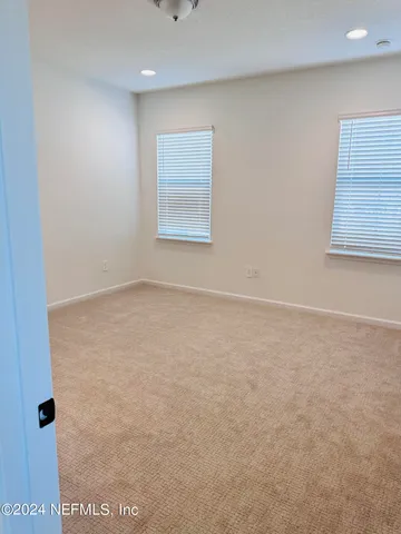 a view of an empty room with windows