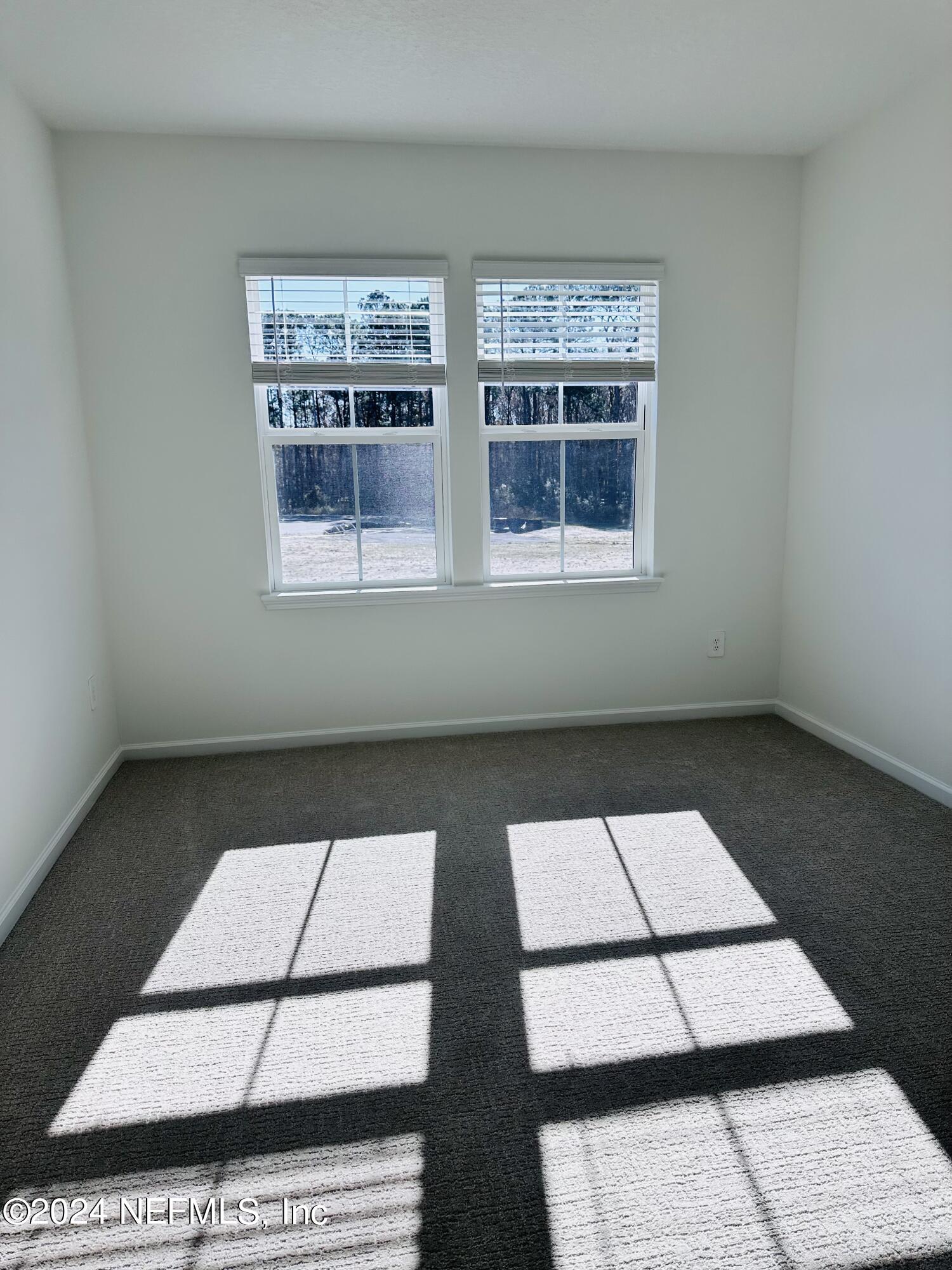 173 Wood Breeze Way St. Augustine, FL 32092 - Photo 18 of 36 a view of an empty room with windows