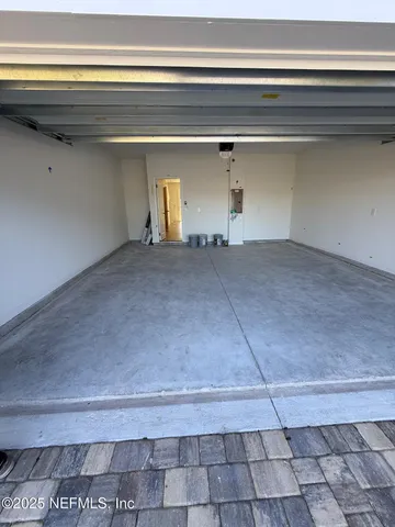 a view of a kitchen with kitchen island a sink wooden floor and a counter top space