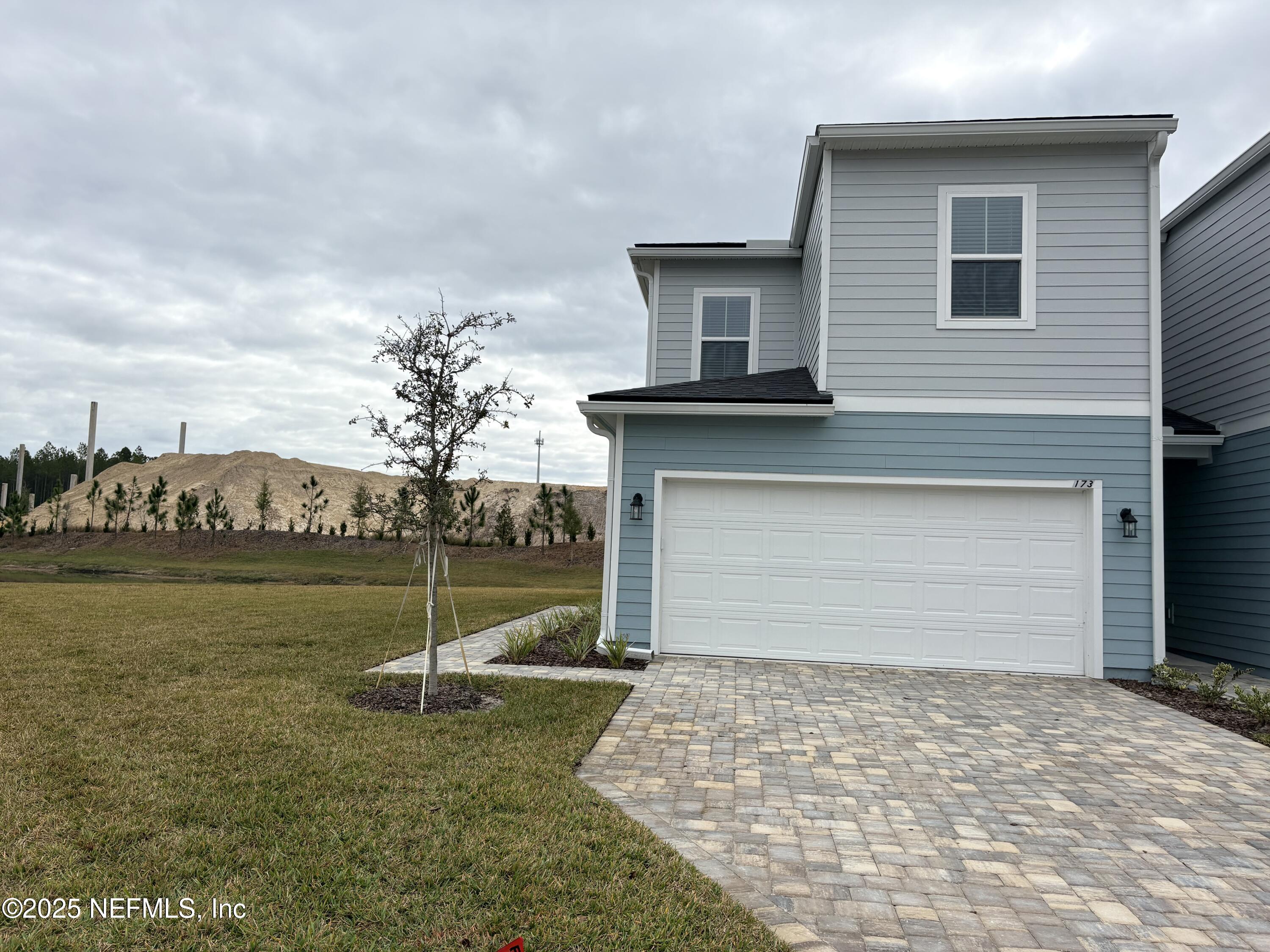 173 Wood Breeze Way St. Augustine, FL 32092 - Photo 35 of 36 a front view of a house with a yard