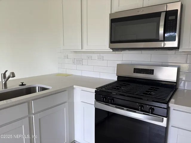 a kitchen with a sink and cabinets