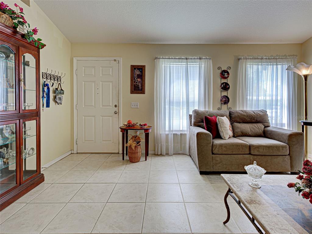 3139 Point Street North Port, FL 34286 - Photo 13 of 58 a living room with furniture a flat screen tv and a window