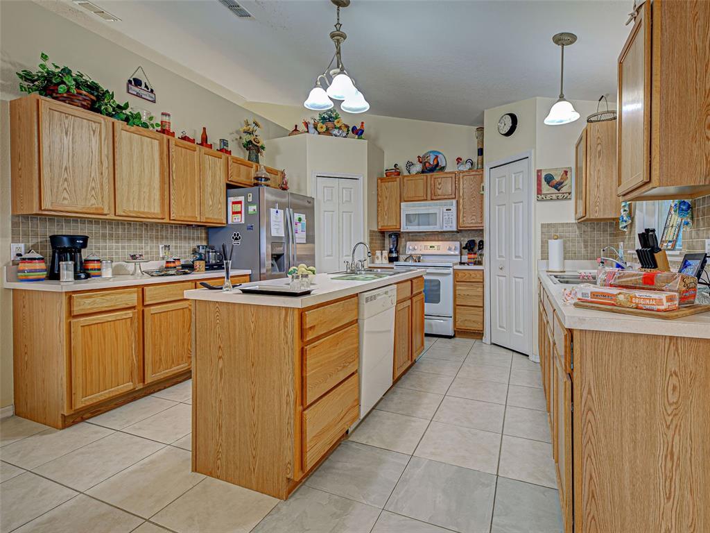 3139 Point Street North Port, FL 34286 - Photo 20 of 58 a kitchen with cabinets a sink and white appliances