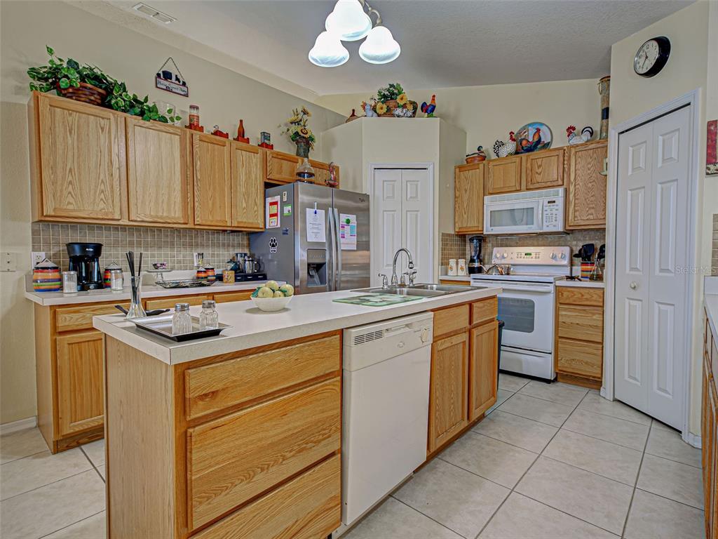 3139 Point Street North Port, FL 34286 - Photo 21 of 58 a kitchen with granite countertop a sink stove top oven and cabinets