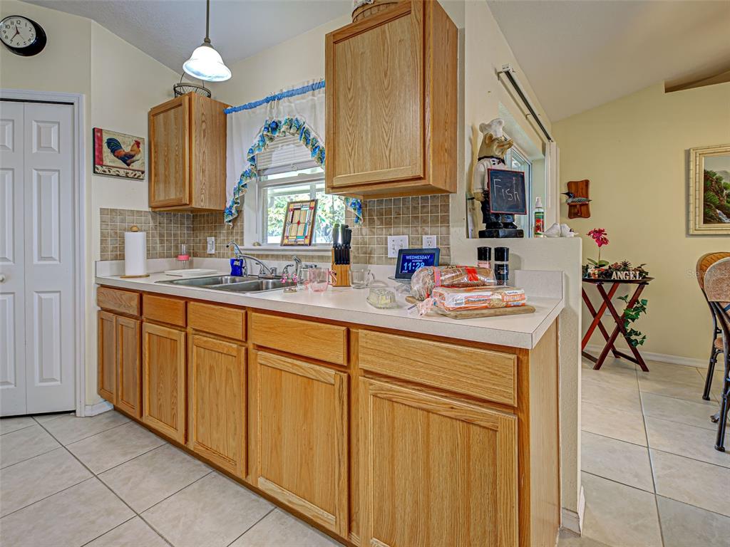 3139 Point Street North Port, FL 34286 - Photo 22 of 58 a kitchen with sink cabinets and window
