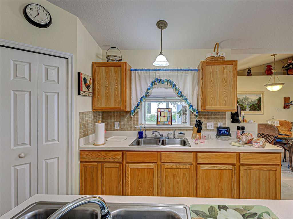 3139 Point Street North Port, FL 34286 - Photo 24 of 58 a kitchen with stainless steel appliances granite countertop a sink dishwasher a stove with wooden cabinets