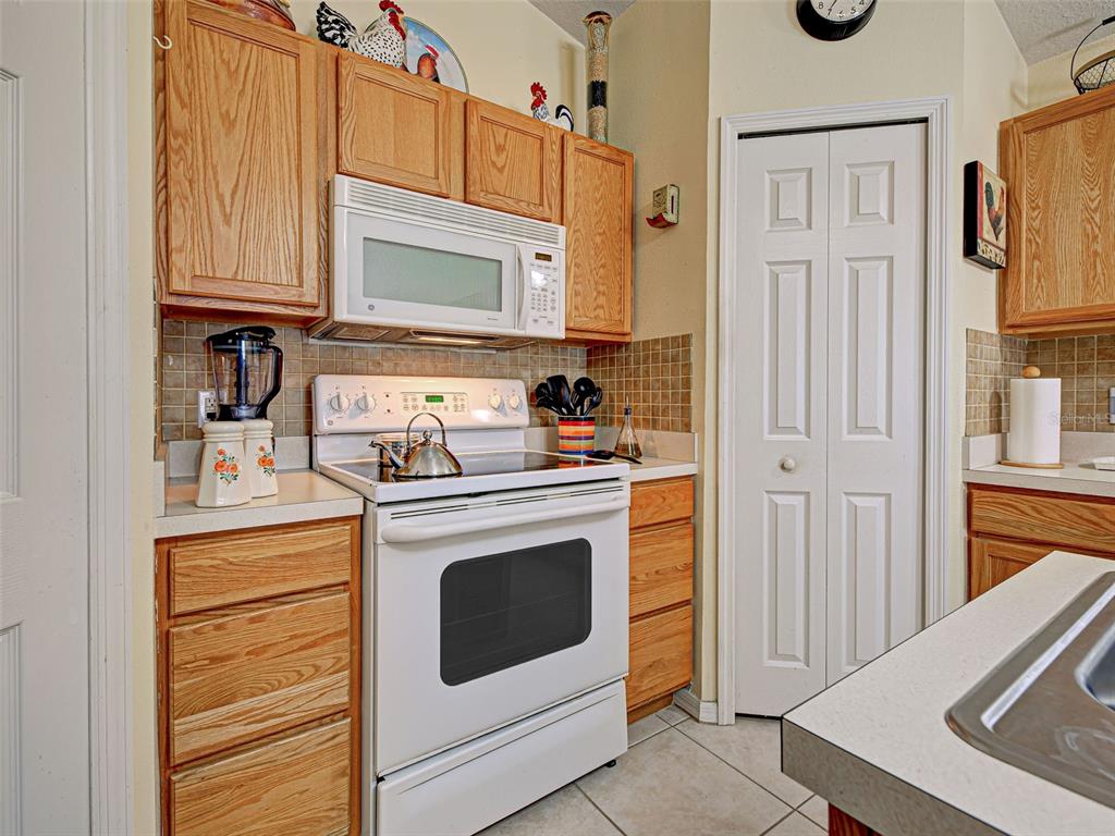 3139 Point Street North Port, FL 34286 - Photo 26 of 58 a kitchen with stainless steel appliances granite countertop a stove a washer and dryer