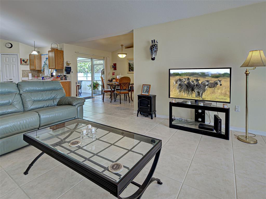 3139 Point Street North Port, FL 34286 - Photo 31 of 58 a living room with furniture and a flat screen tv
