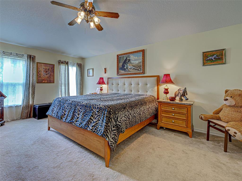 3139 Point Street North Port, FL 34286 - Photo 32 of 58 a bedroom with a bed and a chandelier