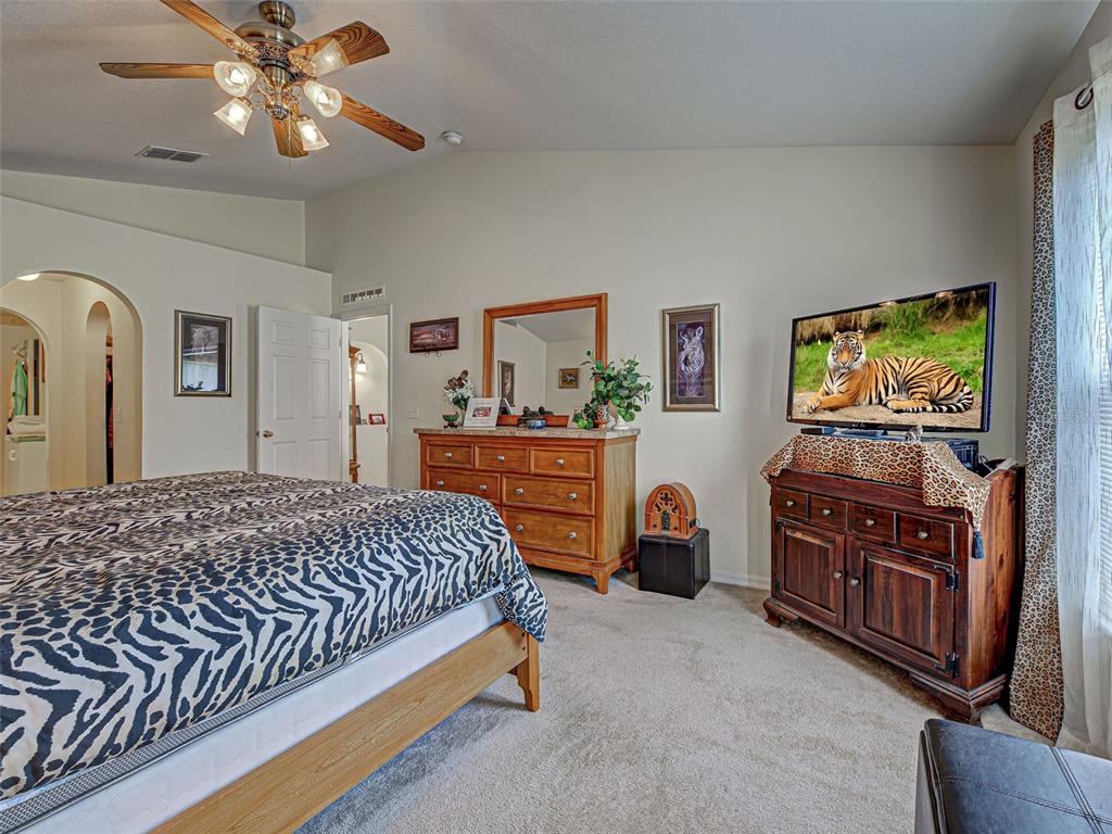 3139 Point Street North Port, FL 34286 - Photo 34 of 58 a bedroom with a bed and dresser with mirror