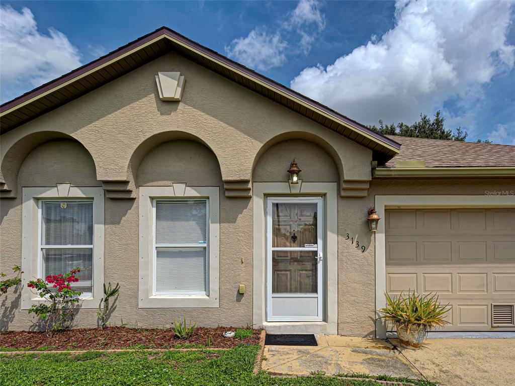 3139 Point Street North Port, FL 34286 - Photo 4 of 58 a front view of a house with garden