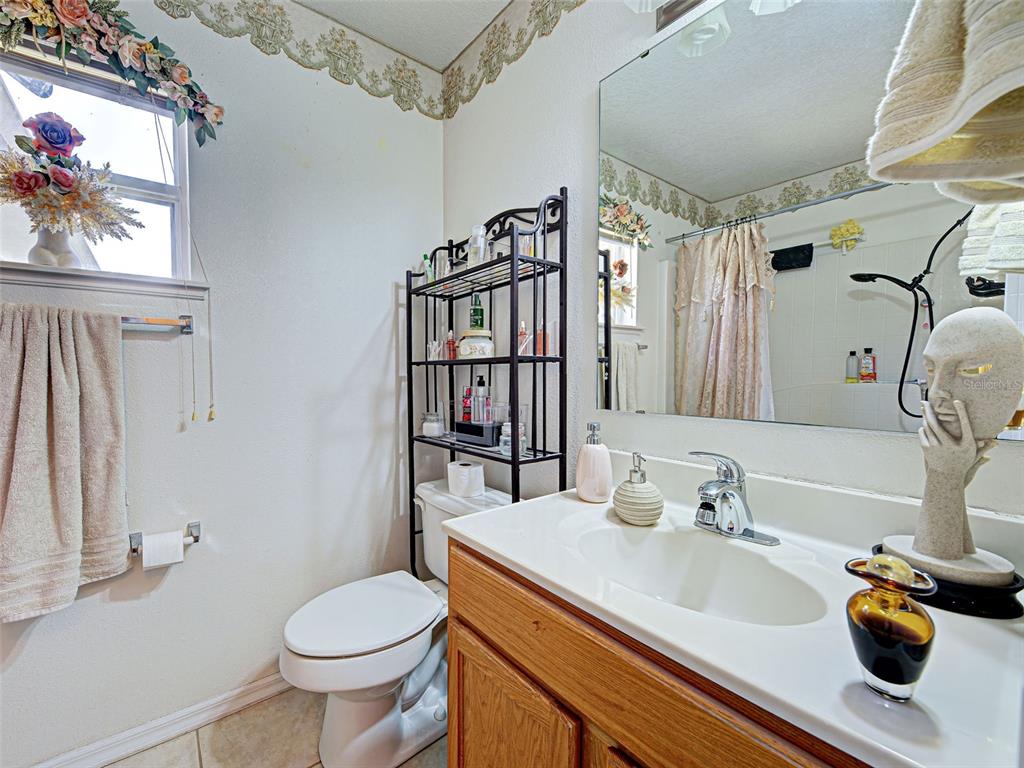 3139 Point Street North Port, FL 34286 - Photo 46 of 58 a bathroom with a sink a toilet and a mirror