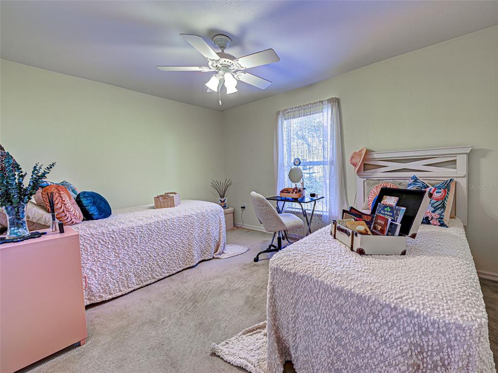 3139 Point Street North Port, FL 34286 - Photo 47 of 58 a bedroom with two beds and a chandelier