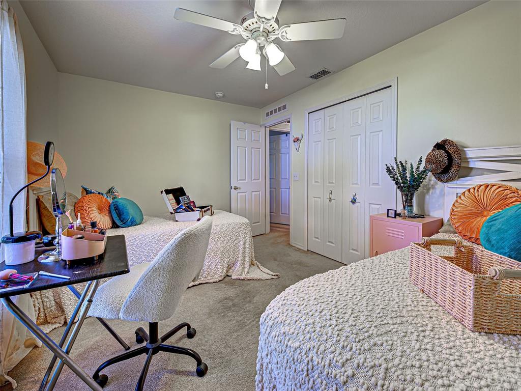 3139 Point Street North Port, FL 34286 - Photo 48 of 58 a bedroom with a bed and a chandelier