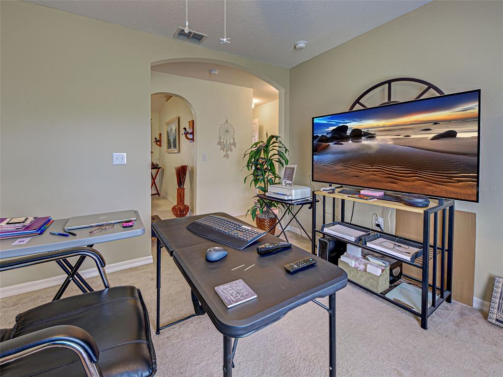 3139 Point Street North Port, FL 34286 - Photo 50 of 58 a living room with furniture and a flat screen tv