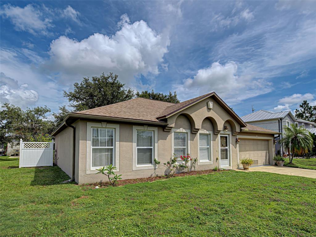3139 Point Street North Port, FL 34286 - Photo 5 of 58 a front view of a house with a garden and yard