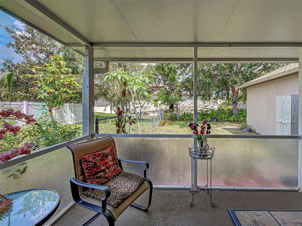 3139 Point Street North Port, FL 34286 - Photo 53 of 58 a living room with furniture and a floor to ceiling window