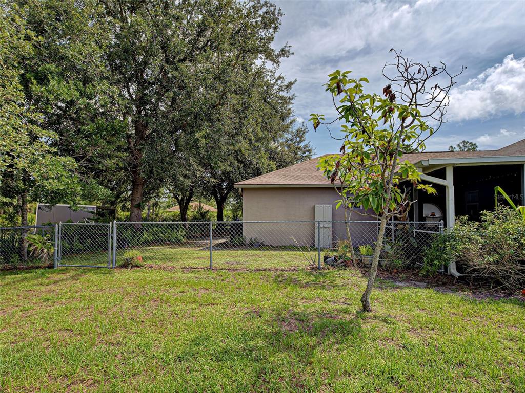 3139 Point Street North Port, FL 34286 - Photo 7 of 58 a backyard of a house with table and chairs