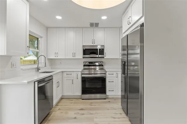 a kitchen with a stove and a sink