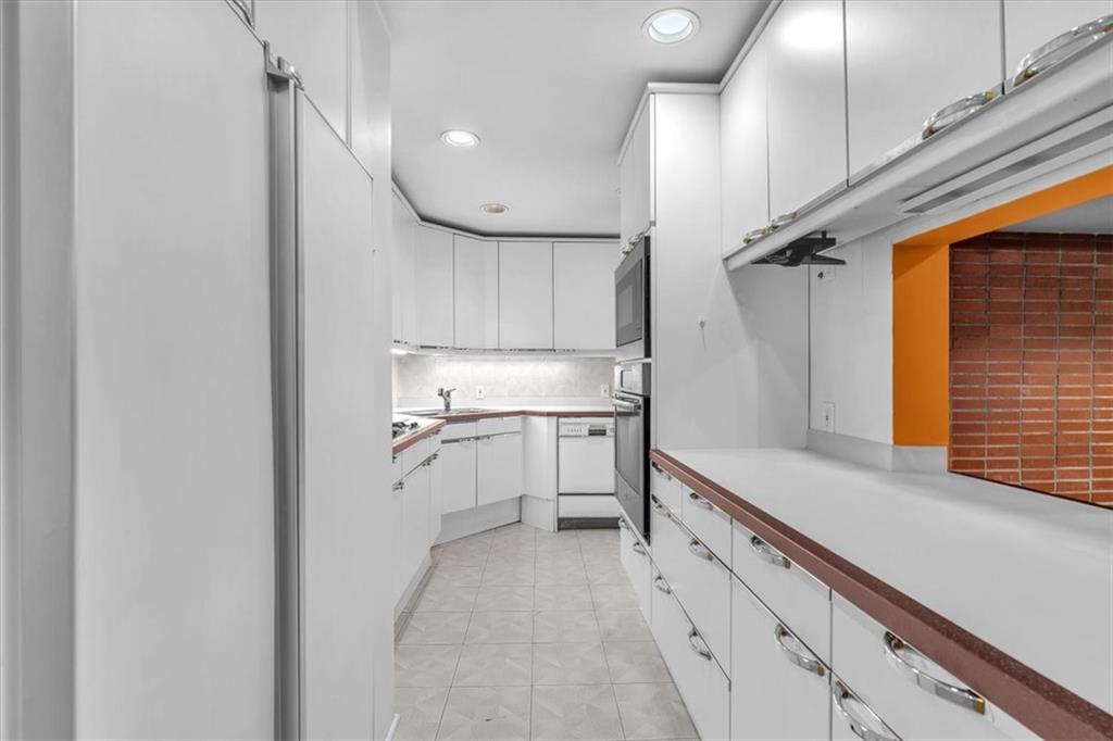 136 Fairfax Road Pittsburgh, PA 15221 - Photo 14 of 50 a kitchen with white cabinets and white appliances