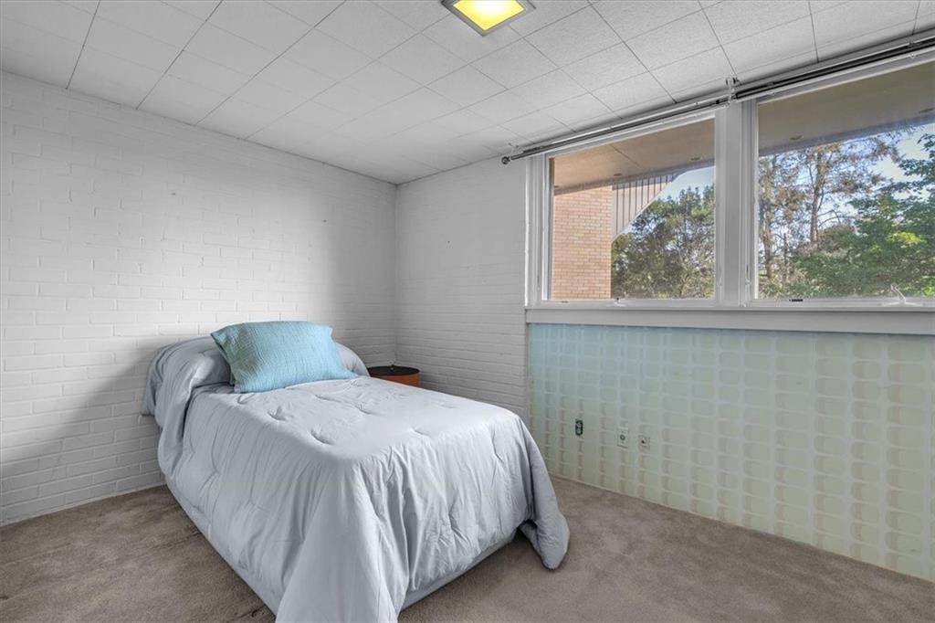 136 Fairfax Road Pittsburgh, PA 15221 - Photo 24 of 50 a bed sitting in a bedroom next to a window