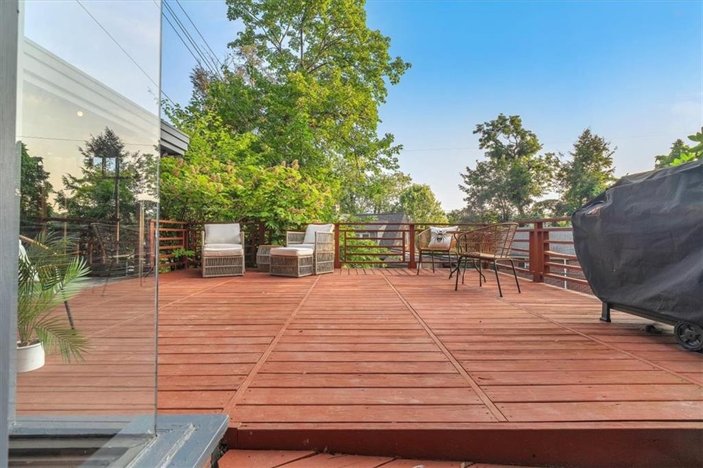 136 Fairfax Road Pittsburgh, PA 15221 - Photo 30 of 50 a patio with table and chairs and potted plants with wooden floor and fence