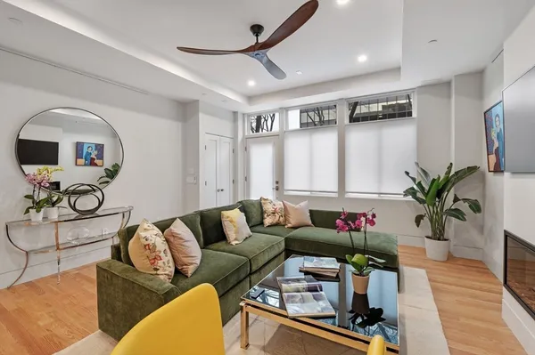 a living room with furniture potted plant and a window