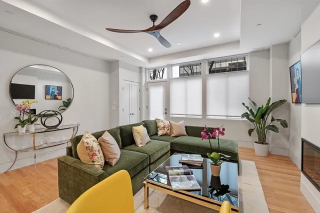 a living room with furniture potted plant and a window