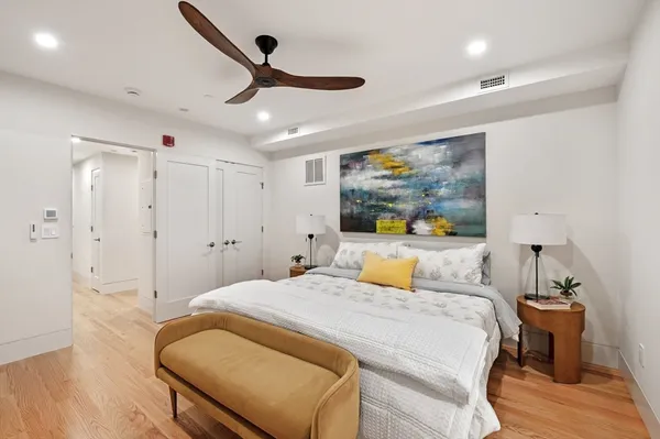 a bedroom with a large bed and a chandelier