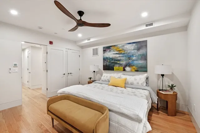a bedroom with a large bed and a chandelier