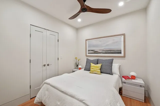 a bedroom with a bed and a painting on the wall