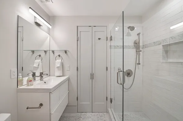 a bathroom with a mirror sink and shower