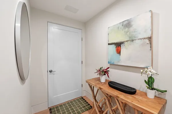 a room with a potted plant on the counter and a sink
