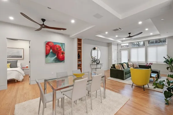 a living room with furniture a window and a flat screen tv