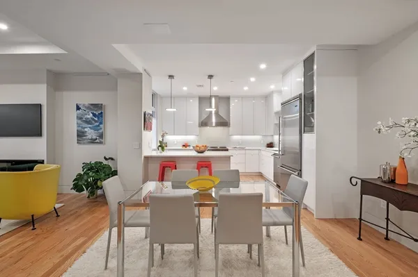a view of a dining room with furniture and wooden floor