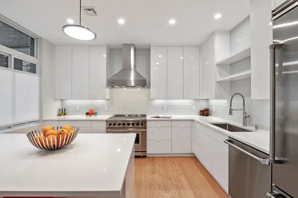 a kitchen with sink a stove and chairs