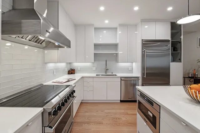 a kitchen with a sink stove and refrigerator
