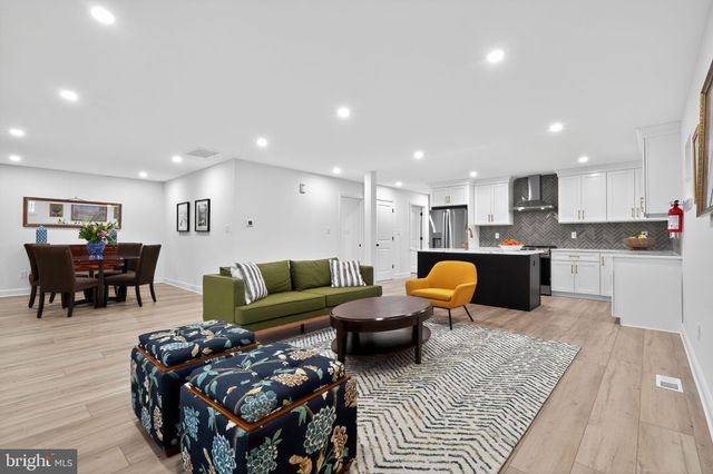 a living room with furniture and kitchen view