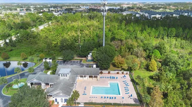 an aerial view of residential houses with outdoor space and lake view