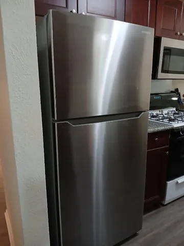 a kitchen with stainless steel appliances granite countertop a stove and a microwave