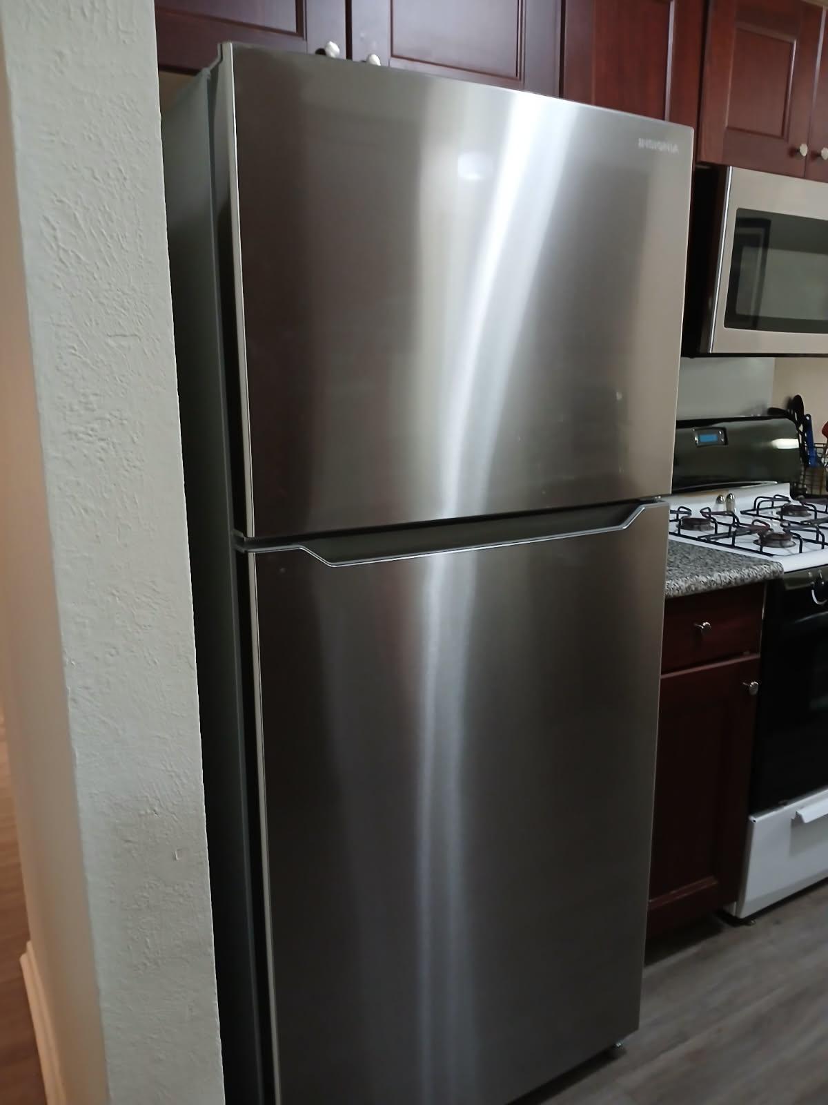 12905 Pegasus Street Austin, TX 78727 - Photo 11 of 32 a close view of a refrigerator and a stove in a kitchen